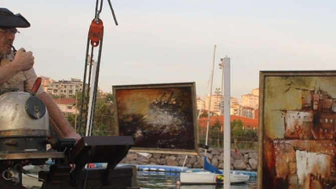 Russian artist displays works on his schooner